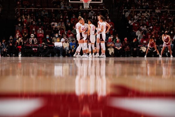 Stanford women's basketball players huddle up on the court