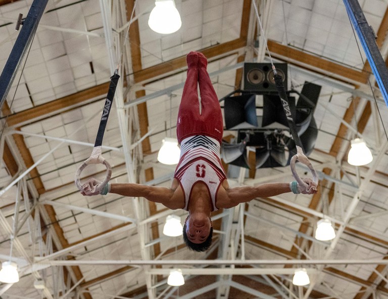 Senior Thomas Lee competes on the still rings.