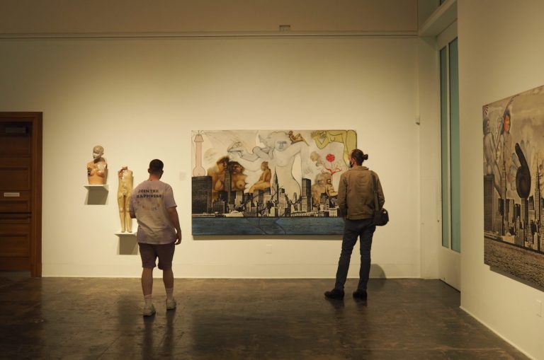 Visitors examine "NY Skyline on Canvas #1" from Steckel's New York Skyline series (Photo: BHUMIKORN KONGTAVEELERT / The Stanford Daily)