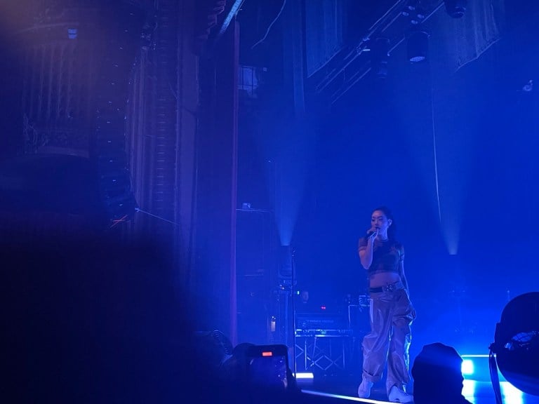 Rina Sawayama performing in front of fans at The Warfield theatre