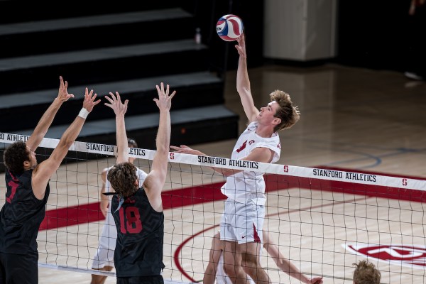 Redshirt sophomore middle blocker Ethan Hill hits.