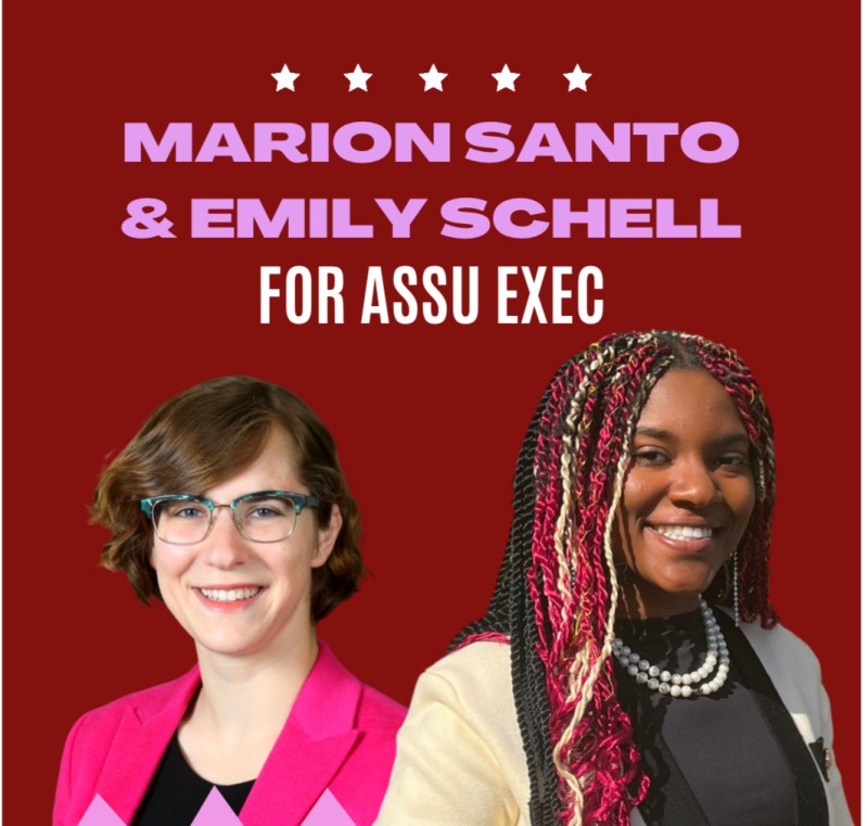 Marion Santo and Emily Schell in front of a poster that reads Marion Santo & Emily Schell for ASSU Exec