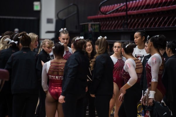 Stanford women's gymnastics gather as a team.