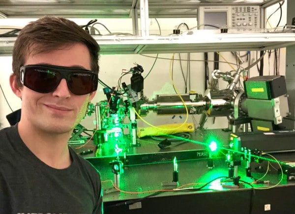man in sunglasses in front of laser technology