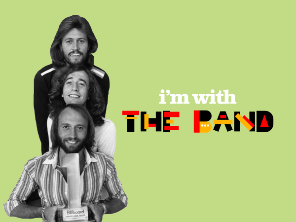 The Bee Gees, in black in white, on top of a pastel green background with the text "i'm with THE BAND." From top to bottom, Barry, Robin and Maurice Gibb sit, smiling.