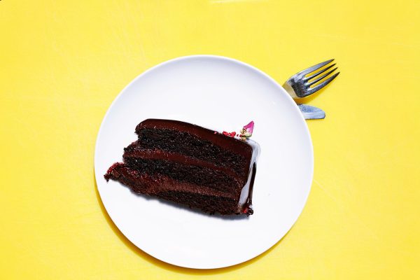 a chocolate cake on a plate in front of a fork