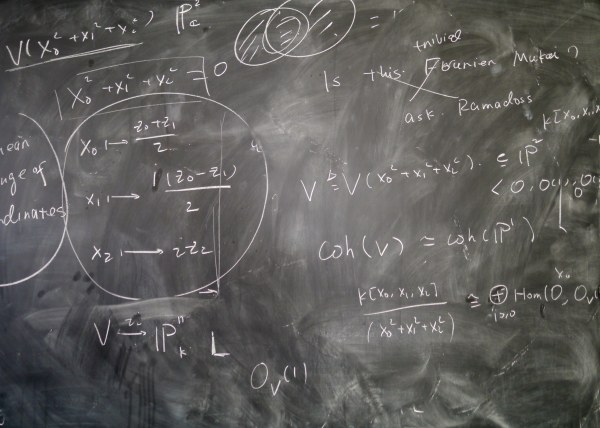 a chalkboard with various mathematical equations written in chalk