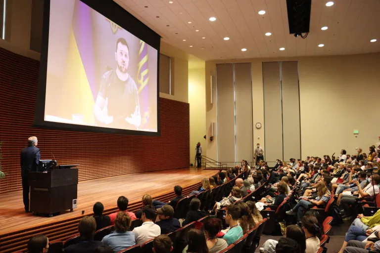 Attendees gather in CEMEX auditorium to watch a virtual address from Zelensky, who is on a big screen