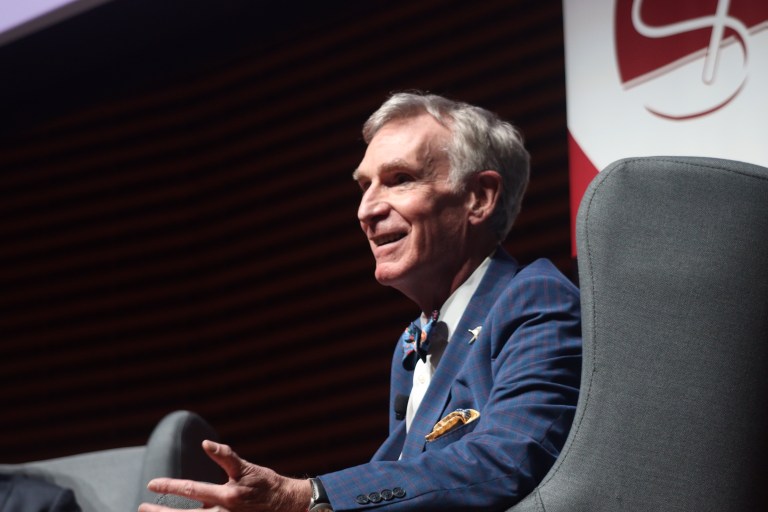 Bill Nye on stage in a chair