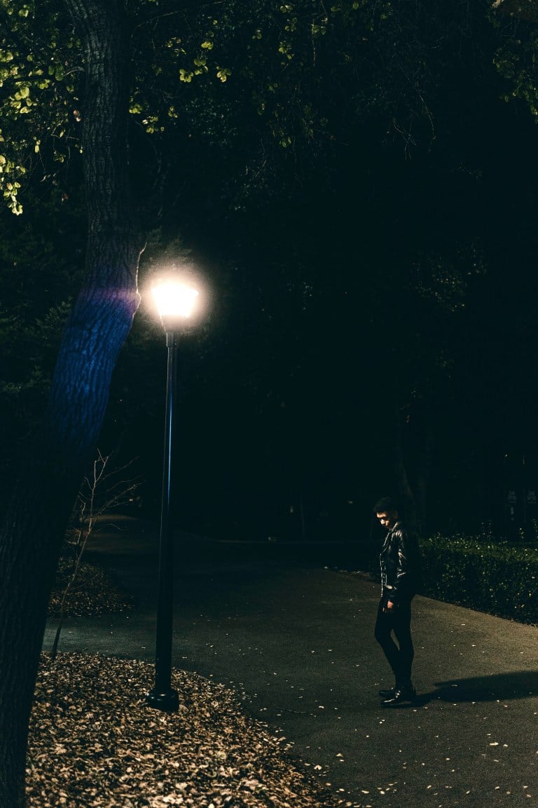 Kevin Martin stands under a lamp post as he looks downward