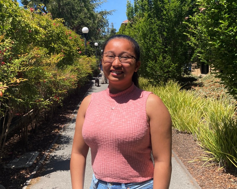 Image of Raenacia Deleon Guerrero '24 smiling on Stanford's campus. 