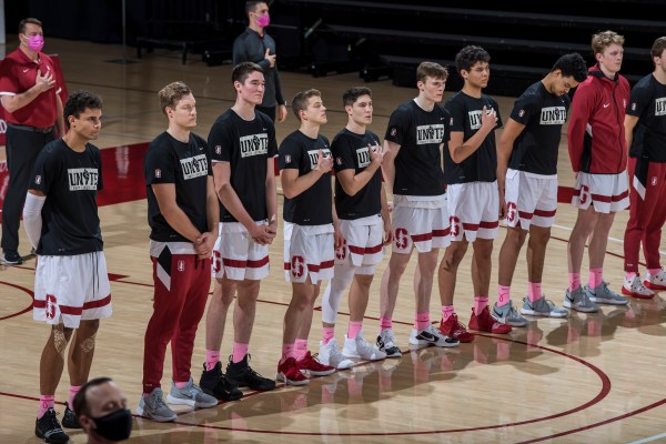 The Stanford men's basketball team stands for the national anthem.