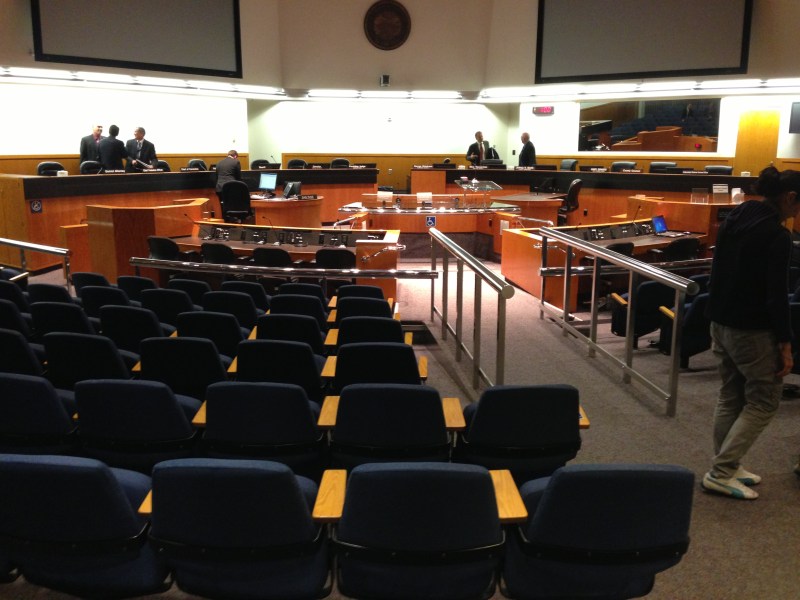 The interior of the Santa Clara board of supervisors chambers, filled with rows of chairs facing a semi-circular desk.