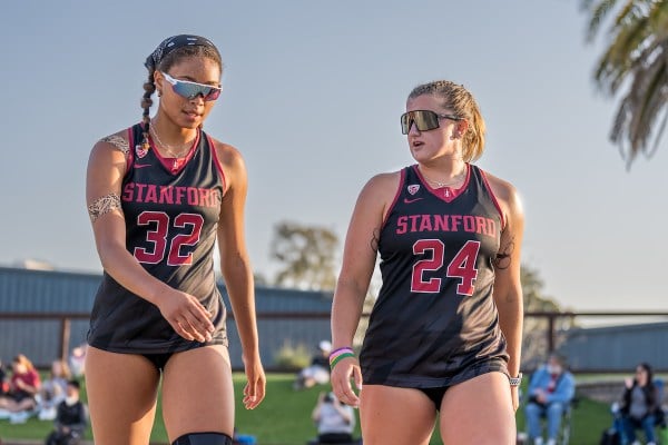 Sophomores Xolani Hodel and Kate Reilly talk during a match at Stanford Beach Volleyball Stadium.