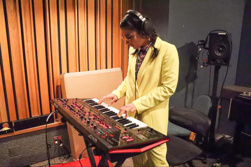 Madame Gandhi plays on a synthesizer 