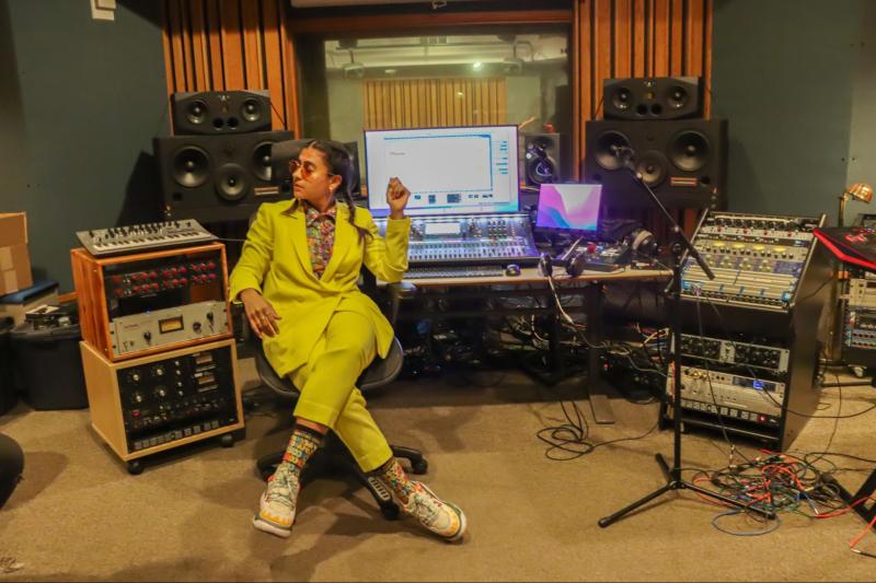 Madame Gandhi poses sitting at the recording studio