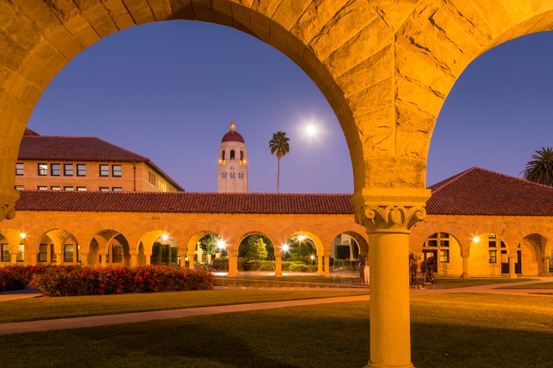 The Center for Comparative Studies in Race and Ethnicity (CCSRE), housed in Building 360. Arches and Hoover Tower visible at dusk