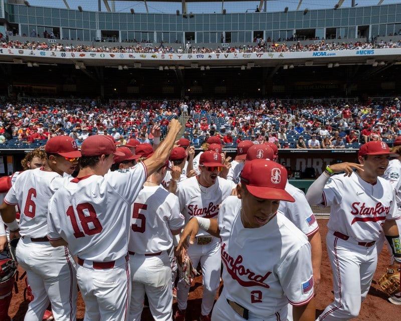 The baseball team breaks from their pre-game huddle at the College World Series.