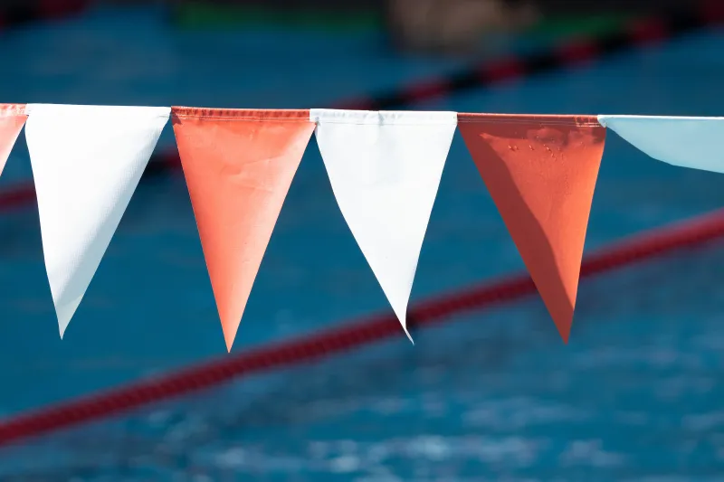 Orange and white flags fly over the pool at Stanford's Avery Aquatic Center.