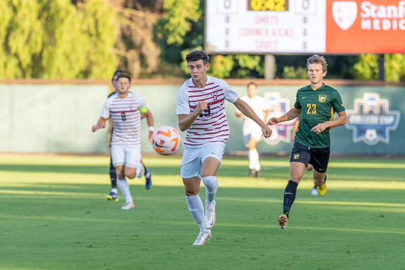Stanford soccer player chases ball down.