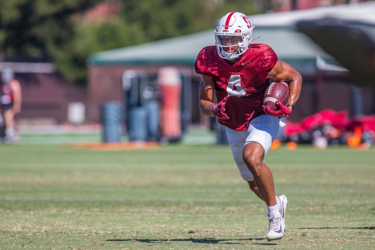 Michael Wilson runs with the ball in open practice