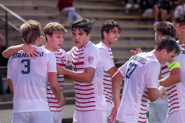 6 Stanford players gather to celebrate a goal.