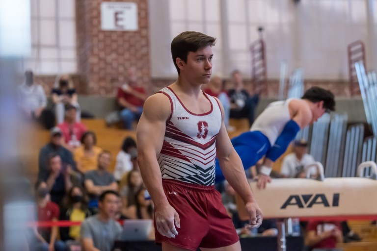 A gymnast outfitted in uniform