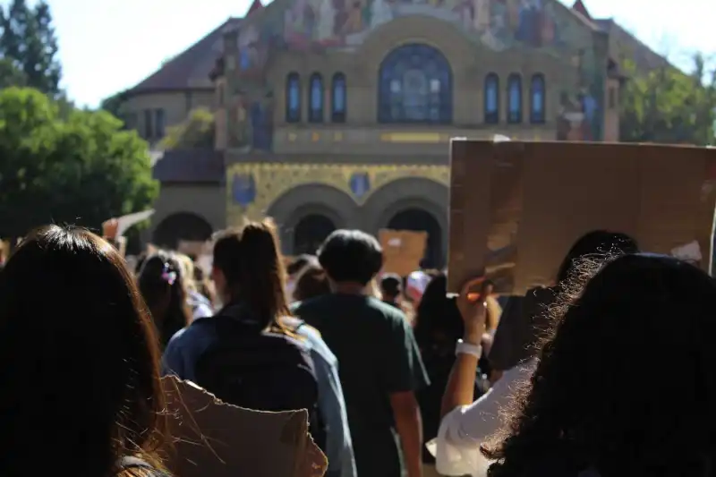 Student protestors walk to Memorial Church