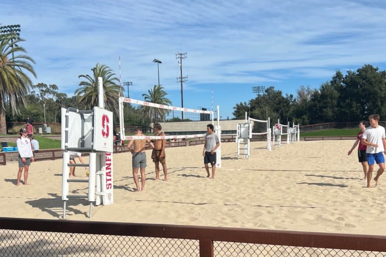 Players on a beach volleyball court