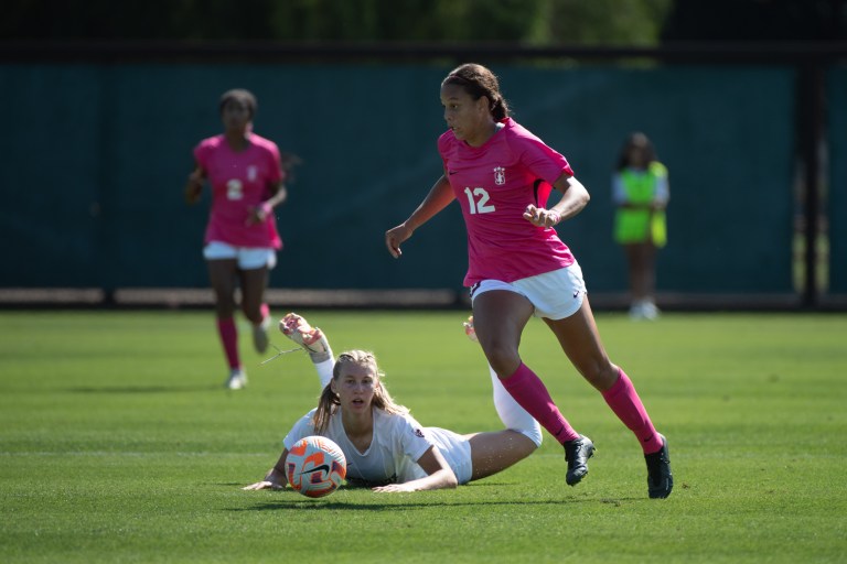 A soccer player dribbles the ball