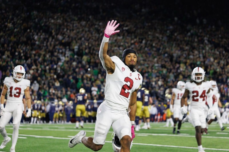 A football player waves to the stands
