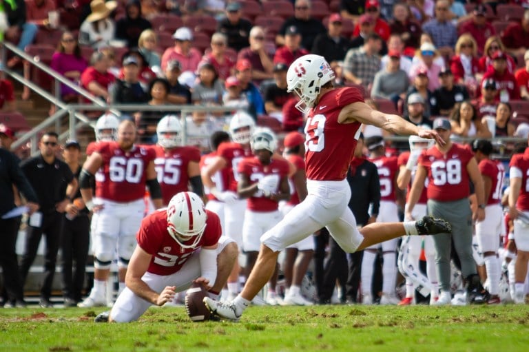 A football player kicks the football