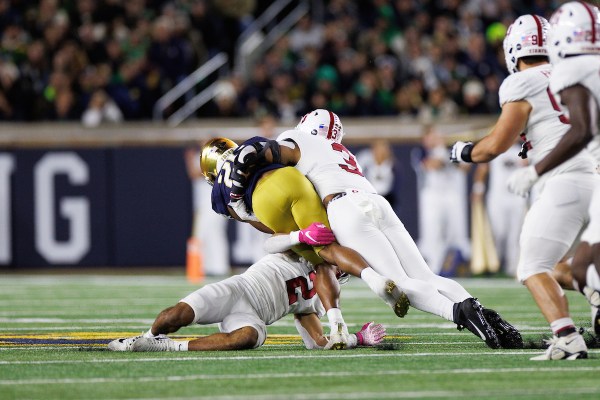 Seniors Jonathan McGill and Levani Damuni team up for a tackle against Notre Dame on Saturday. The defense held the Fighting Irish to just 14 points en route to a Cardinal win. (BOB DREBIN/isiphotos.com)