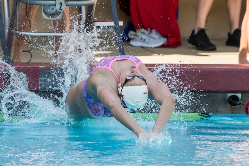 A swimmer does backstroke