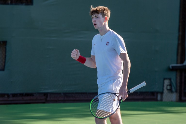 Max Basing clenches his right fist in celebration during a tennis match.