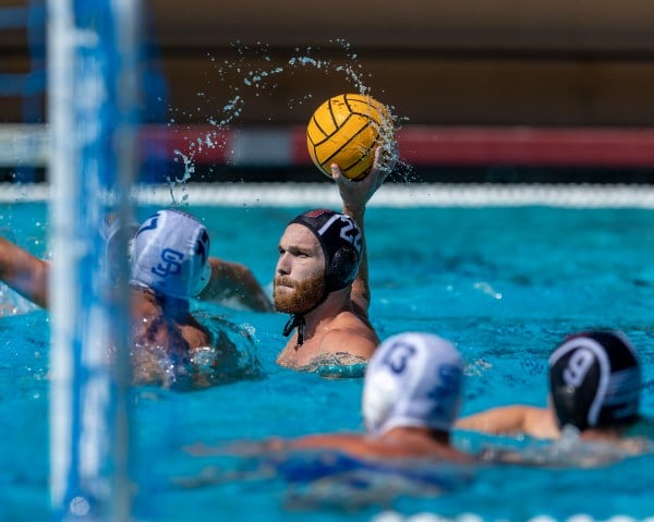 a water polo player looks to score the ball