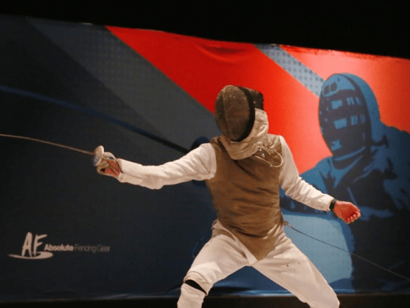 A fencer with a foil lunges