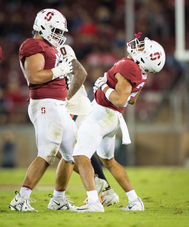 Tobin Phillips and Jonathan McGill laugh together on the Stanford field