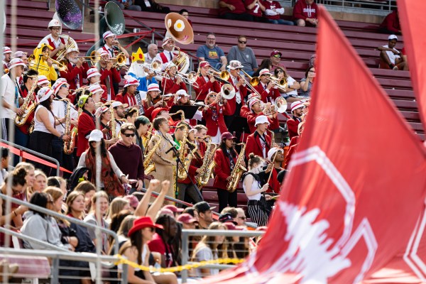 The stanford band plays in the stands at a football game