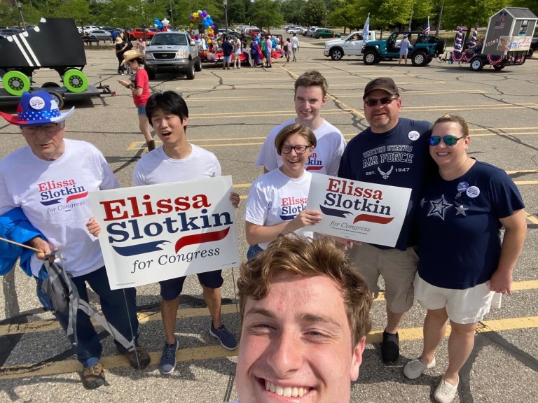 Students hold signs for political candidates