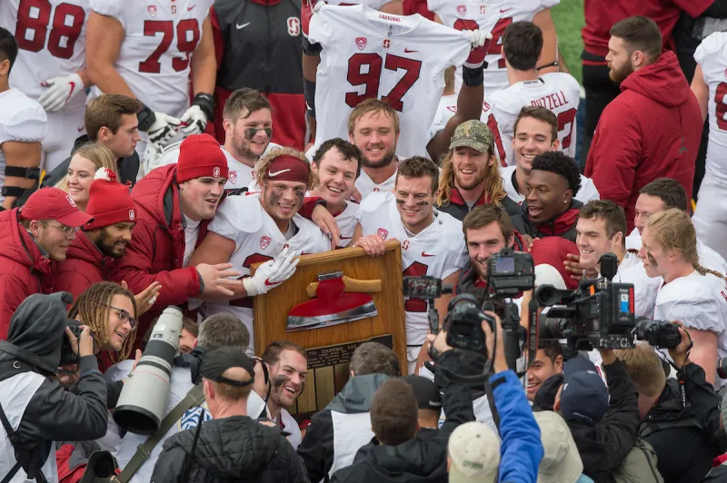Stanford football players hold the Axe trophy