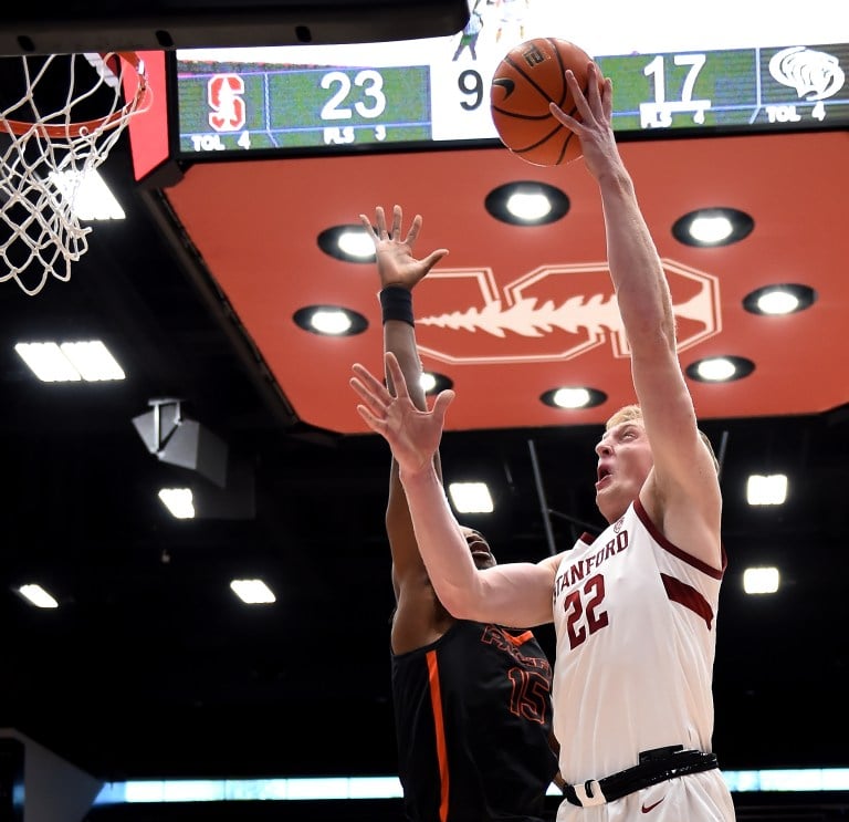 A basketball player goes up for a layup