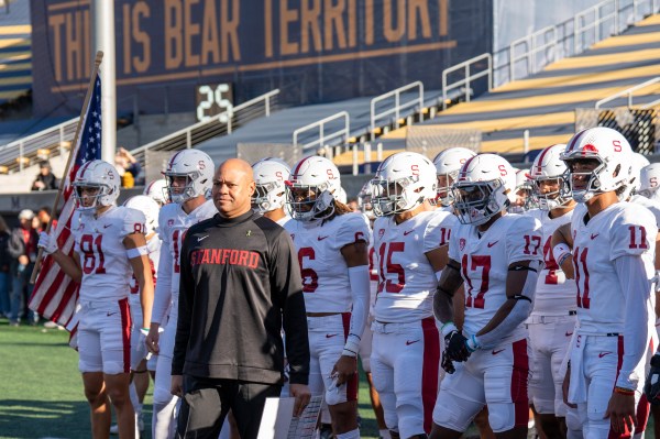 Coach Shaw stands in front of Stanford football players