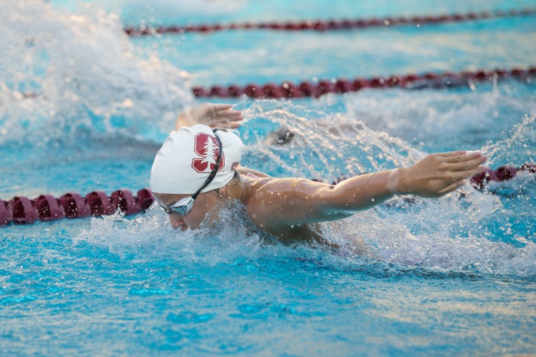 A swimmer emerges from the water