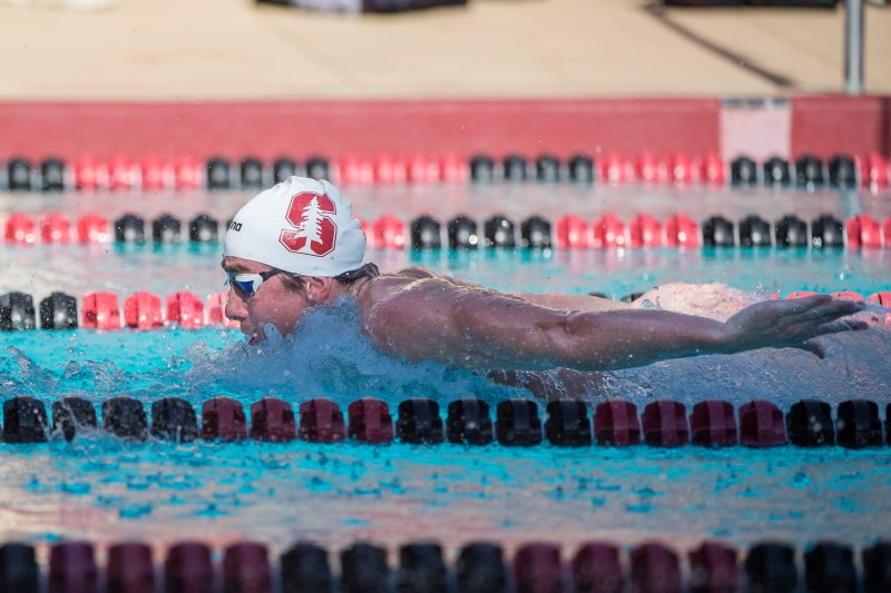 A swimmer is seen mid-stroke coming out of the water