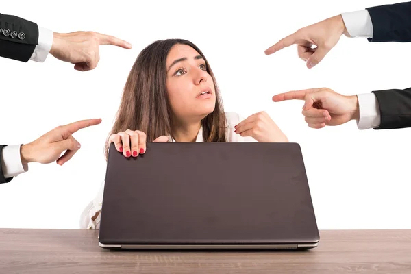 4 people point at a girl using a laptop