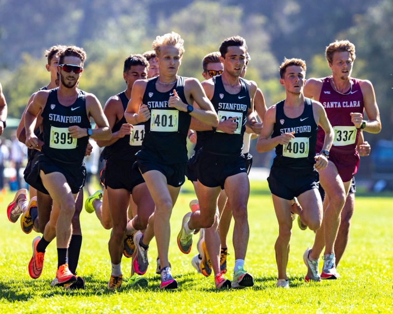 a pack of cross country runners run side-by-side