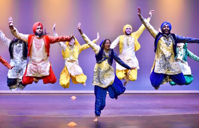 A group of Bhangra dancers jumping in the air