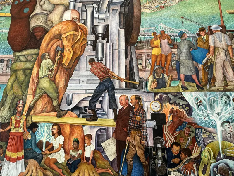 A colorful mural, including elements such as mine and construction workers