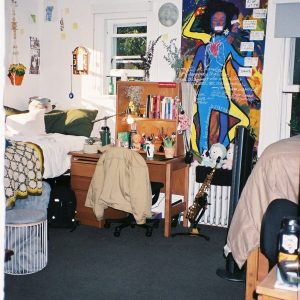 A snippet of the room's layout, focusing on the desk on one roommate's side.